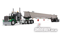 
              DCP by First Gear Black/Green Peterbilt Model 389 Day Cab & ERMC 4-Axle Hydra-Steer Trailer With Bridge Beam Section Load 1/64
            